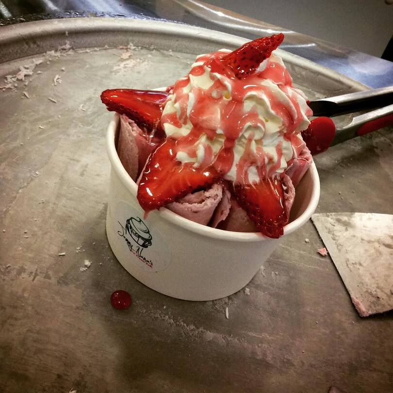 cup of strawberry and vanilla ice cream rolls
